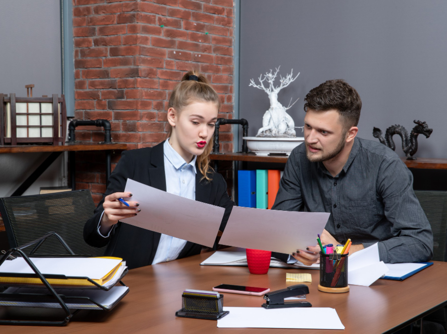 Two colleagues reviewing legal documents in a modern office, representing the professionalism of the best immigration lawyer.