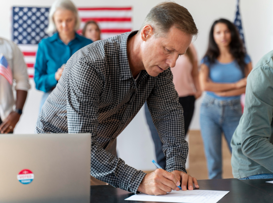 A man signs official documents at a citizenship event, representing the trusted support of the best immigration lawyer in the USA.