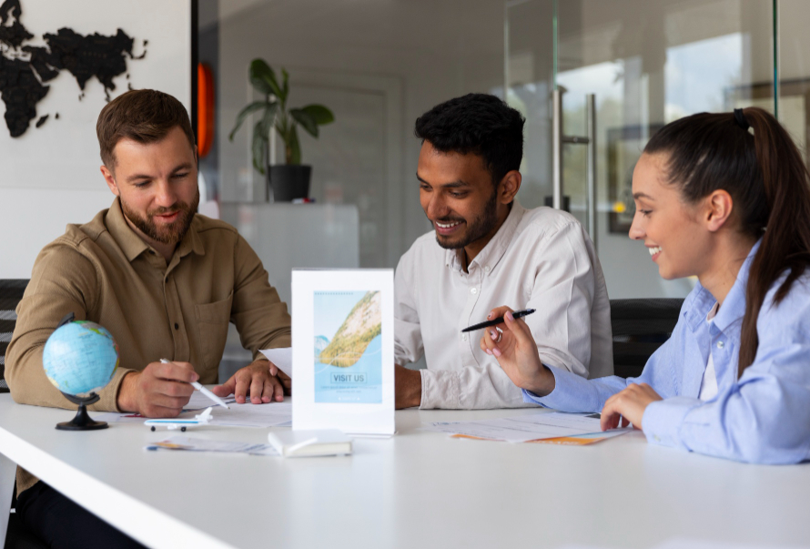 Team discussing U.S. startup and immigration plans at a desk with documents and a small globe.
